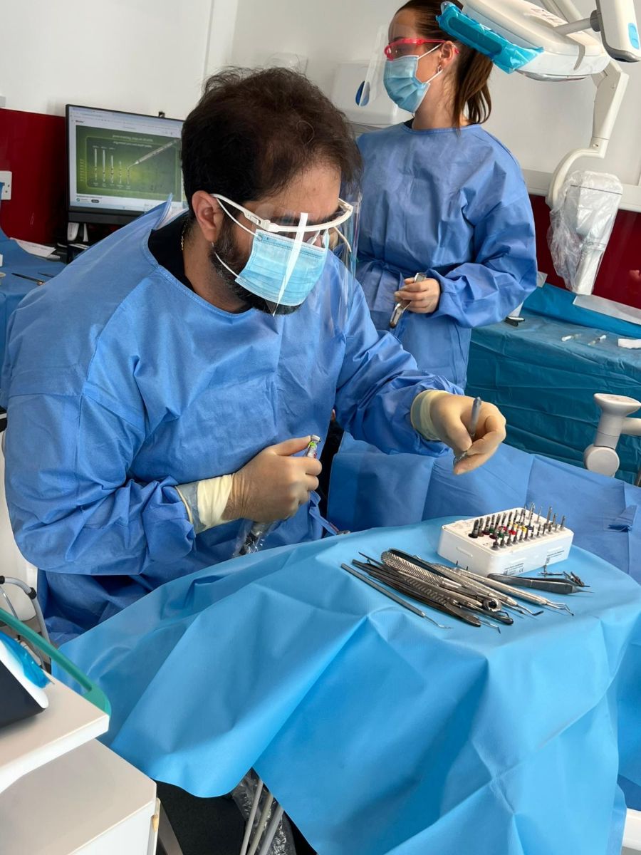 Dr Abbasi and his nurse during implant surgery